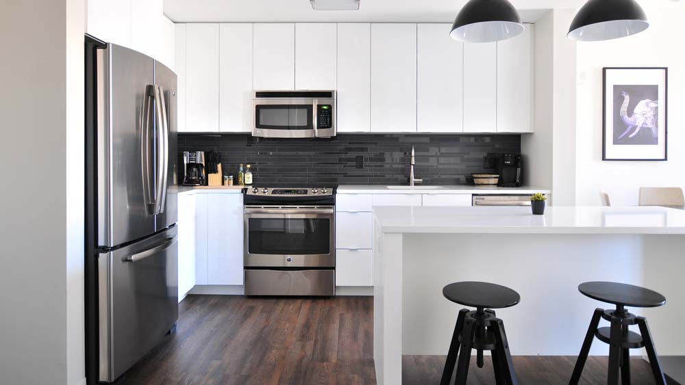 A bright, modern kitchen with a stainless steel fridge